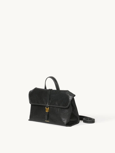 Black Small Shan Satchel Bag in vegetable-tanned leather with gold buckle and white stitching