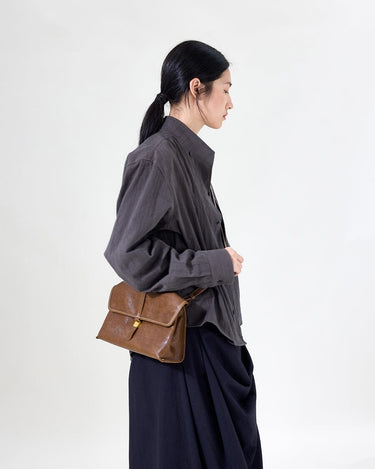 Small Shan Satchel Bag in Sandal color, made of vegetable-tanned leather with a golden clasp.