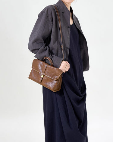 Small Shan Satchel Bag in Sandal color, crafted from vegetable-tanned leather with a golden buckle closure.