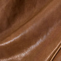 Close-up texture of brown vegetable-tanned leather, Small Shan Satchel Bag in Sandal color.