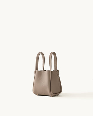 Small cream bucket bag with magnetic closure and gold feet