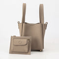Small Song Bag in taupe, made from full-grain leather, with a matching leather pouch.