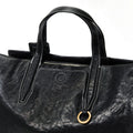Black Small Yore Duffle Bag: textured leather, white stitching, brass hardware. Songmont travel bag.