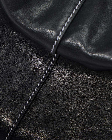 Black Small Yore Duffle Bag: vegetable-tanned leather with white stitching. Elegant travel bag.