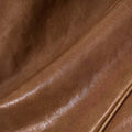 Close-up of Sandal colored vegetable-tanned leather on Small Yore Duffle Bag, showing texture and sheen.