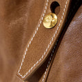 Sandal leather Small Yore Duffle Bag with white stitching and gold emblem detail.