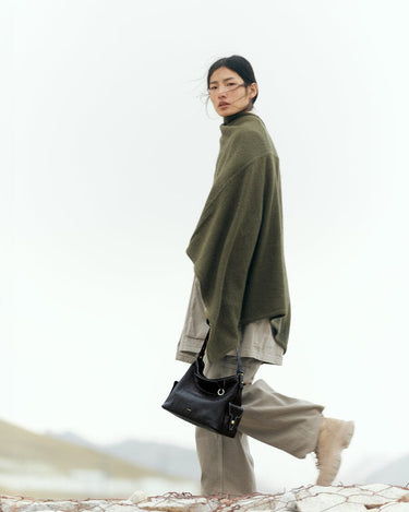 Small Yore Hobo Bag in Onyx crafted from vegetable-tanned leather, featuring adjustable strap and multiple pockets.