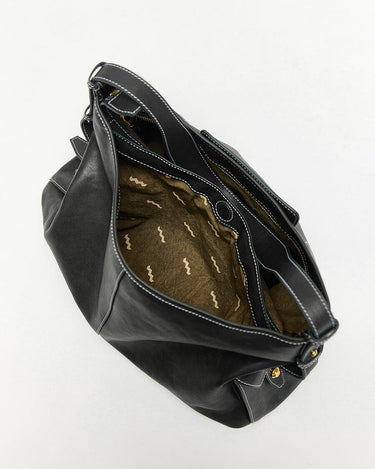Small Yore Hobo Bag in Onyx: Vegetable-tanned leather with white stitching, open view revealing patterned interior lining.