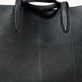 Black textured leather small Yore tote bag with detailed stitching on handles and seams.
