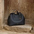 Songmont Small Yore Tote Bag in Onyx, crafted from pebbled full-grain leather with gold hardware.