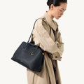 Small Yore Tote Bag in Onyx by Songmont, black pebble-grain leather with gold hardware.