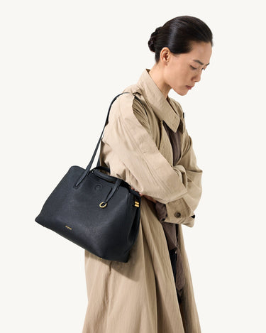 Small Yore Tote Bag in Onyx by Songmont, black pebble-grain leather with gold hardware.