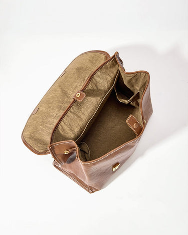 Large Shan Briefcase in Sandal leather, open to show interior compartments and laptop pocket.