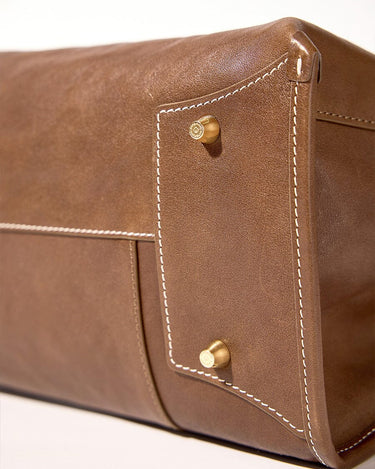 Large Shan Briefcase in Sandal brown leather, white stitching, brass hardware.