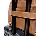 Sandal leather Large Shan Briefcase secured to suitcase handle. Features white stitching & 'songmont' branding.