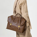 The Large Shan Briefcase in Sandal color, crafted from vegetable-tanned leather with brass hardware.