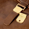 Large Shan Briefcase: Sandal leather, gold clasp with 'Songmont' logo, patterned detail.