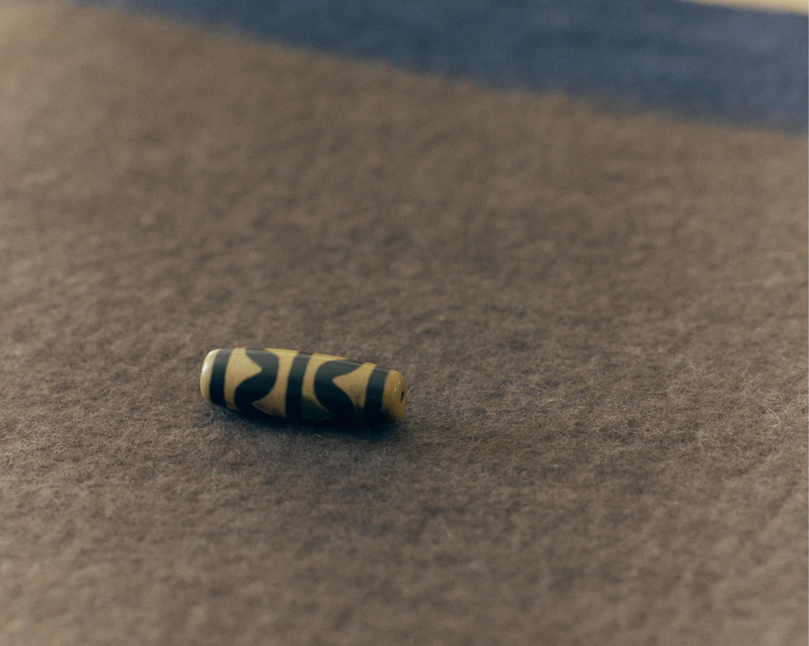 Striped cylindrical object on a textured surface