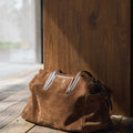 Medium Yore Duffle Bag, Sandal Suede: brown cow suede, leather trim, stainless steel hardware.