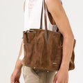 Medium Yore Duffle Bag in Sandal Suede. Cow suede leather with leather trim, white stitching, and stainless steel hardware.