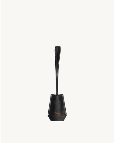 The Yore Key Chain made of black vegetable-tanned leather with white stitching and a subtle embossed logo.