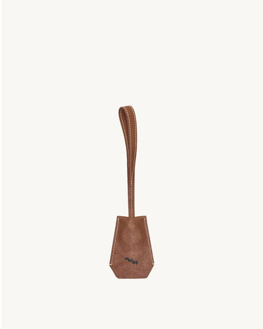 Sandal brown Yore Key Chain made of vegetable-tanned leather with embossed logo, perfect as a bag charm or key holder.