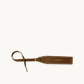 The Yore Luggage Tag in vegetable-tanned leather with "Songmont" embossed.
