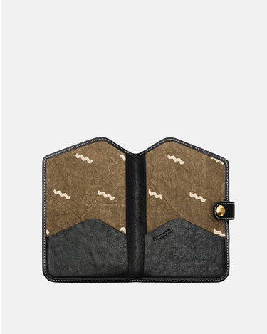 The Yore Passport Case in Onyx, interior view with card slots and tiger tooth lining.
