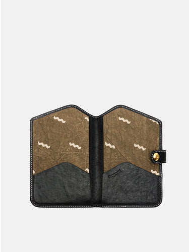 The Yore Passport Case in Onyx, interior view with card slots and tiger tooth lining.