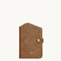 Brown Yore Passport Case in Sandal color by Songmont, featuring vegetable-tanned leather and a brass snap closure.