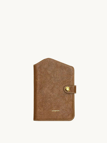 Brown Yore Passport Case in Sandal color by Songmont, featuring vegetable-tanned leather and a brass snap closure.