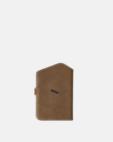 The Yore Passport Case in Sandal color, made of vegetable-tanned leather with a subtle wave logo.