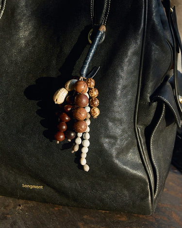 Denim Wish Seeds Charm crafted from full-grain leather with a beaded charm featuring natural Bodhi seeds.
