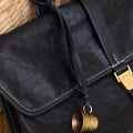 Worry-Free Cup Charm: Black leather bag with brass thimble charm, adjustable strap. Vegetable-tanned leather.