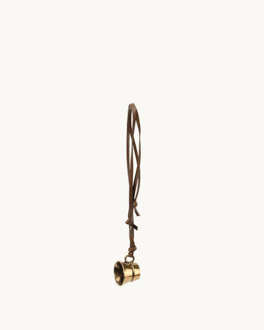 Vintage-inspired brass cup charm with adjustable leather cord, ideal for bags and necklaces.