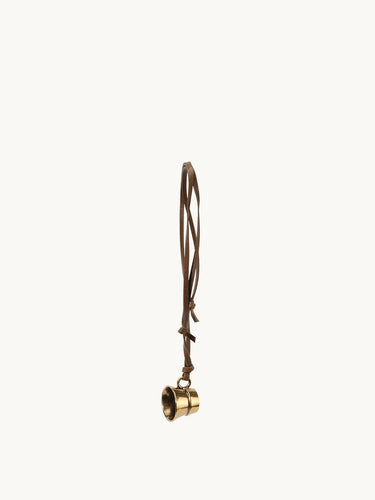 Vintage-inspired brass cup charm with adjustable leather cord, ideal for bags and necklaces.