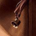 Sandal colored Worry-Free Cup Charm with aged metal finish and leather tie