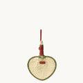 Woven fan charm with green trim and red handle, crafted from palm fronds