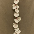 Woven fan charm garland made of heart-shaped palm frond fans with green trim and red tags.