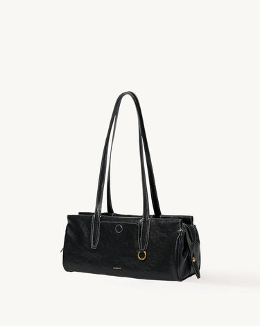 Black Yore Baguette Bag, vegetable-tanned leather, white stitching, gold hardware. Modern and structured design.