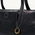 Black Songmont Yore Baguette Bag with gold ring hardware and contrast stitching