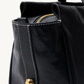 Yore Baguette Bag in Onyx: Black vegetable-tanned leather with white stitching and gold hardware.