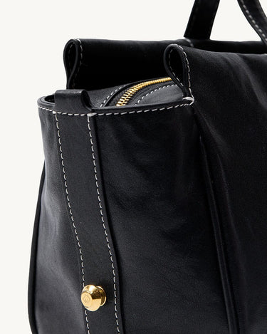Yore Baguette Bag in Onyx: Black vegetable-tanned leather with white stitching and gold hardware.