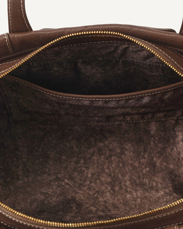 Brown Yore Baguette Bag interior with slip pocket and gold zipper, vegetable-tanned leather