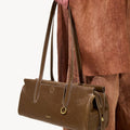 Yore Baguette Bag in Sandal color, made of vegetable-tanned leather with white stitching and gold hardware.