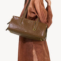 Yore Baguette Bag in Sandal: vegetable-tanned leather, white stitching, gold hardware. Modern, structured design.
