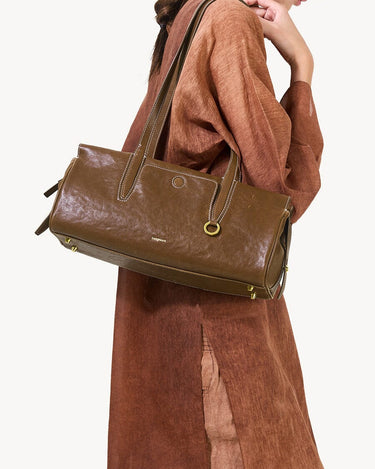 Yore Baguette Bag in Sandal: vegetable-tanned leather, white stitching, gold hardware. Modern, structured design.