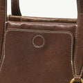 Brown leather Yore Baguette Bag with white stitching and gold hardware