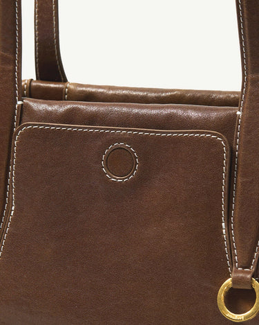 Brown leather Yore Baguette Bag with white stitching and gold hardware