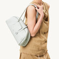 Pale blue full-grain leather Yore Toast Bag with vacuum electroplated hardware worn by a model.